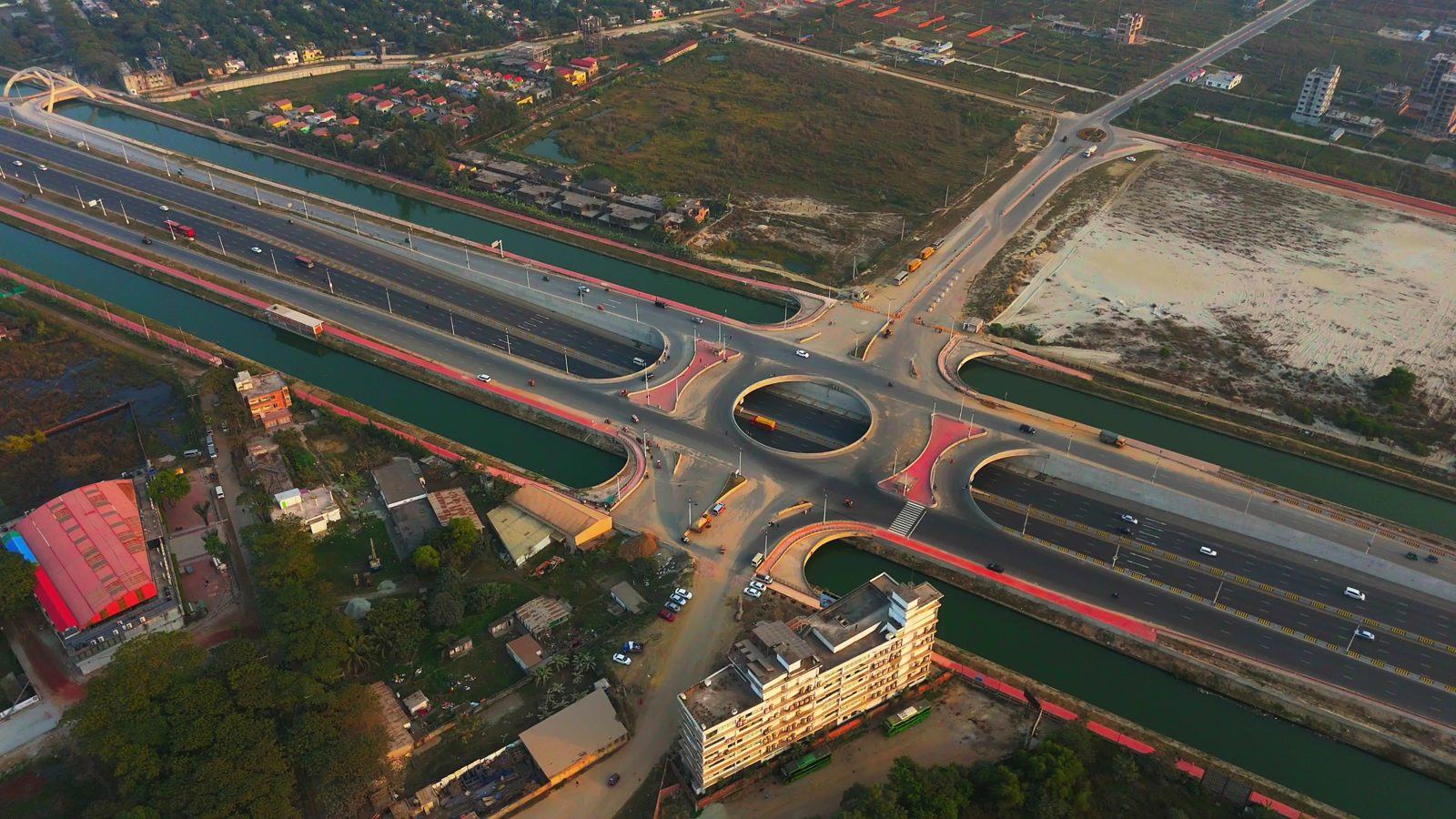 Drone photo of an expressway interchange with canals, with the road, water and vegetation each shaded as regions